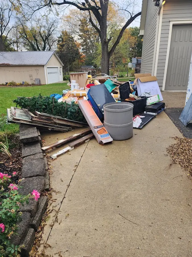 Dumpster being loaded with debris for 12 Yard Dumpster Rental in Cordes Lakes